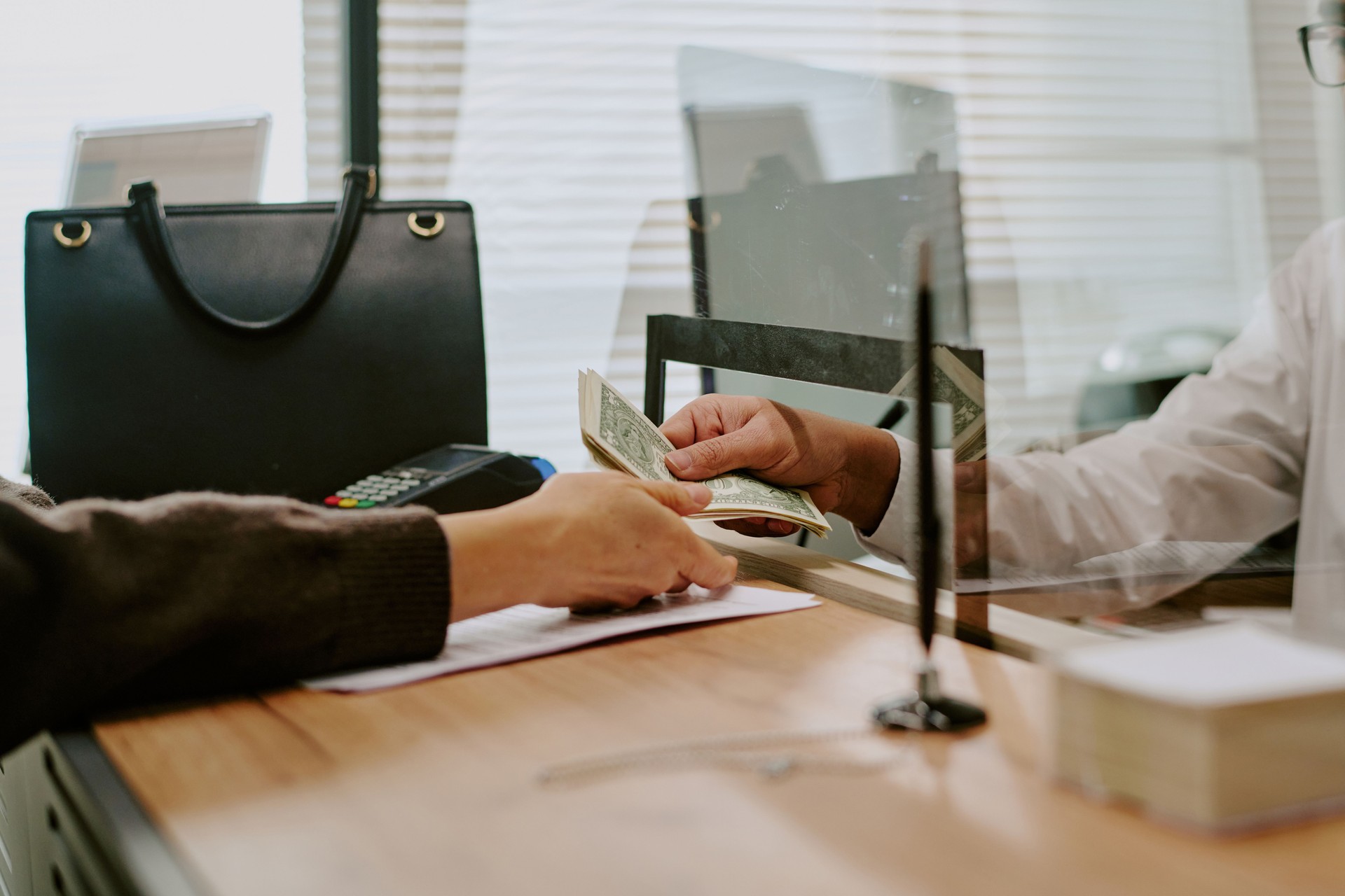 Handing Over Cash Payment in Office Setting