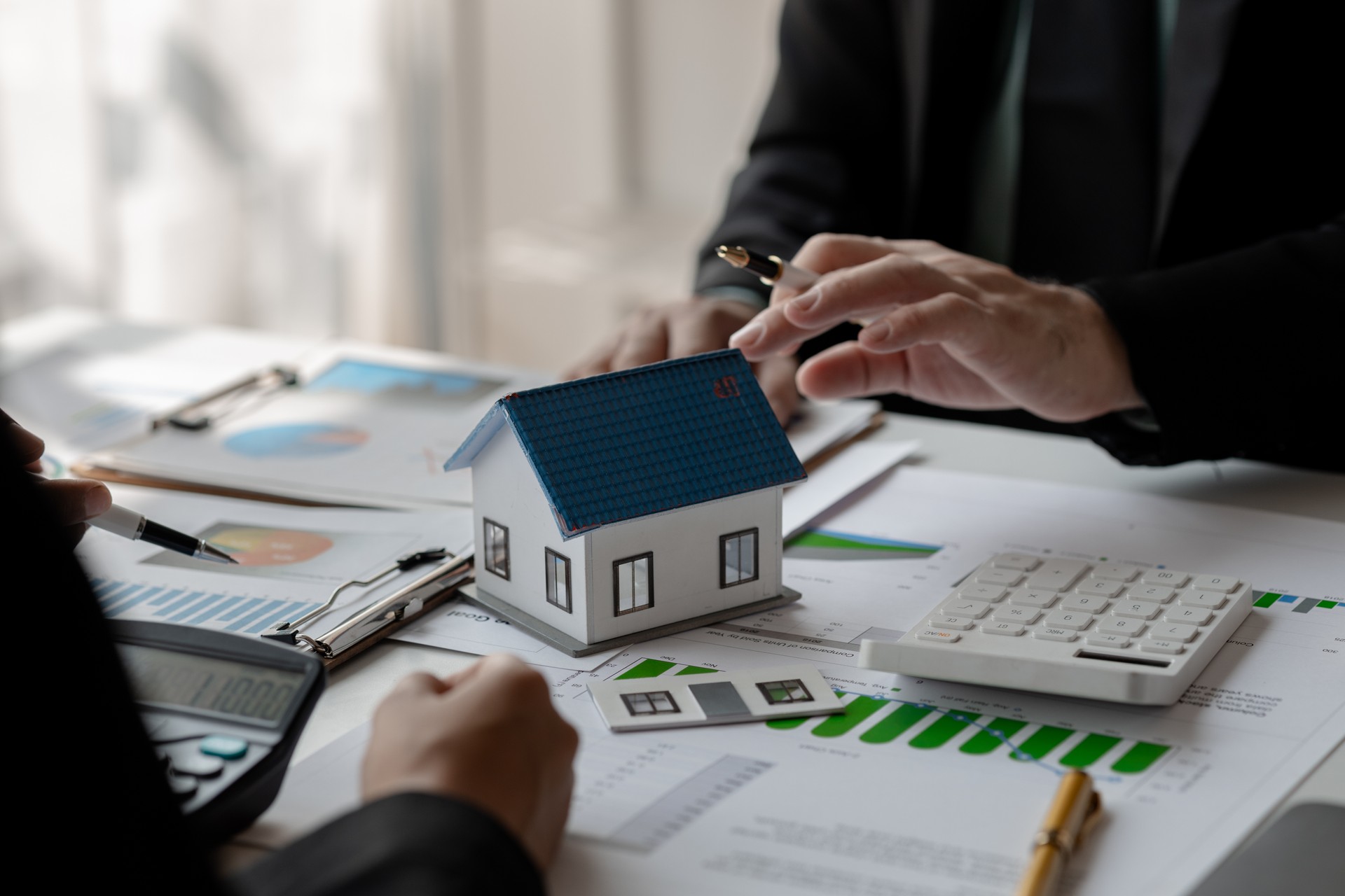 accommodation agency and client are planning together about finance because the client wanted to buy a house, meeting in property office with expert of how to find the best house for rent